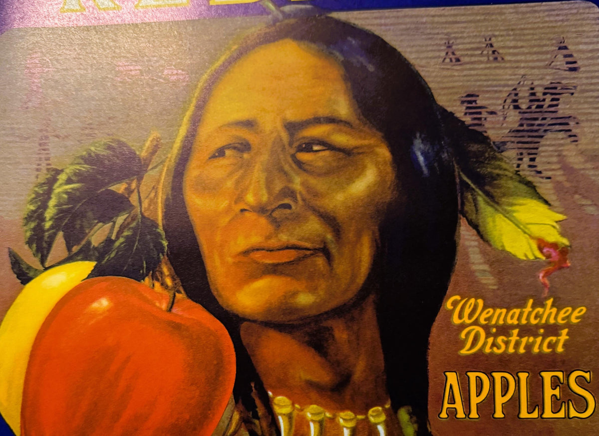 Vintage Wenatchee District Apples crate label featuring portrait of Native American man with long dark hair and red apple, ye