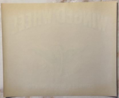 Blank cream-colored vintage crate label with curved bottom edge, photographed flat against white background