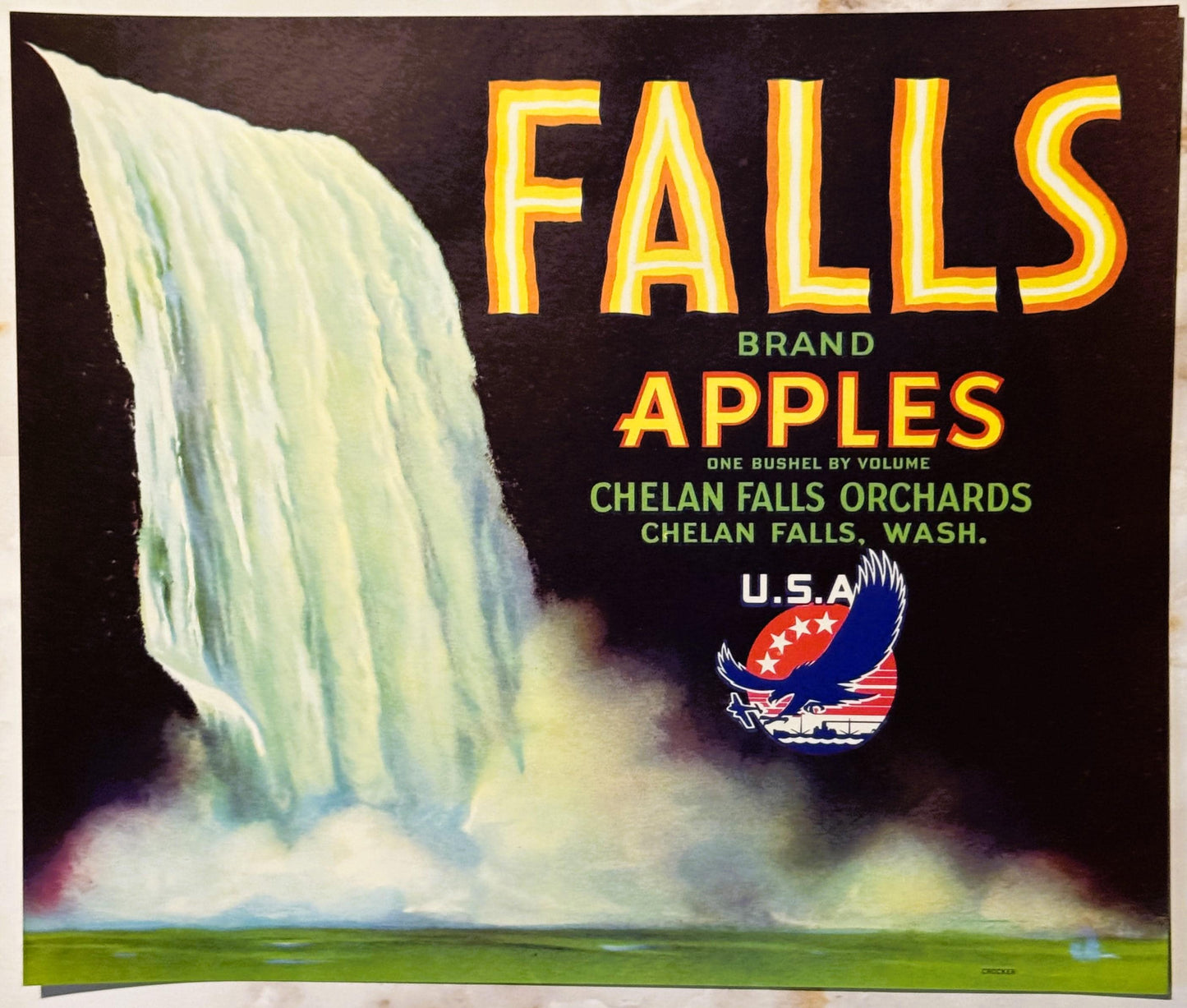 Vintage apple crate label with dramatic waterfall image, gold "FALLS BRAND APPLES" text, and USA eagle logo on black backgrou