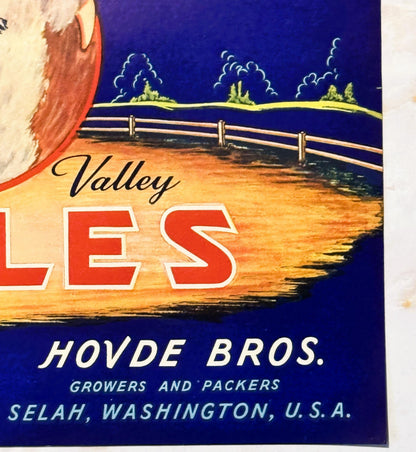 Vintage Hereford brand apple crate label with eagle head, ranch fence, and trees against deep blue sky; red and gold text rea