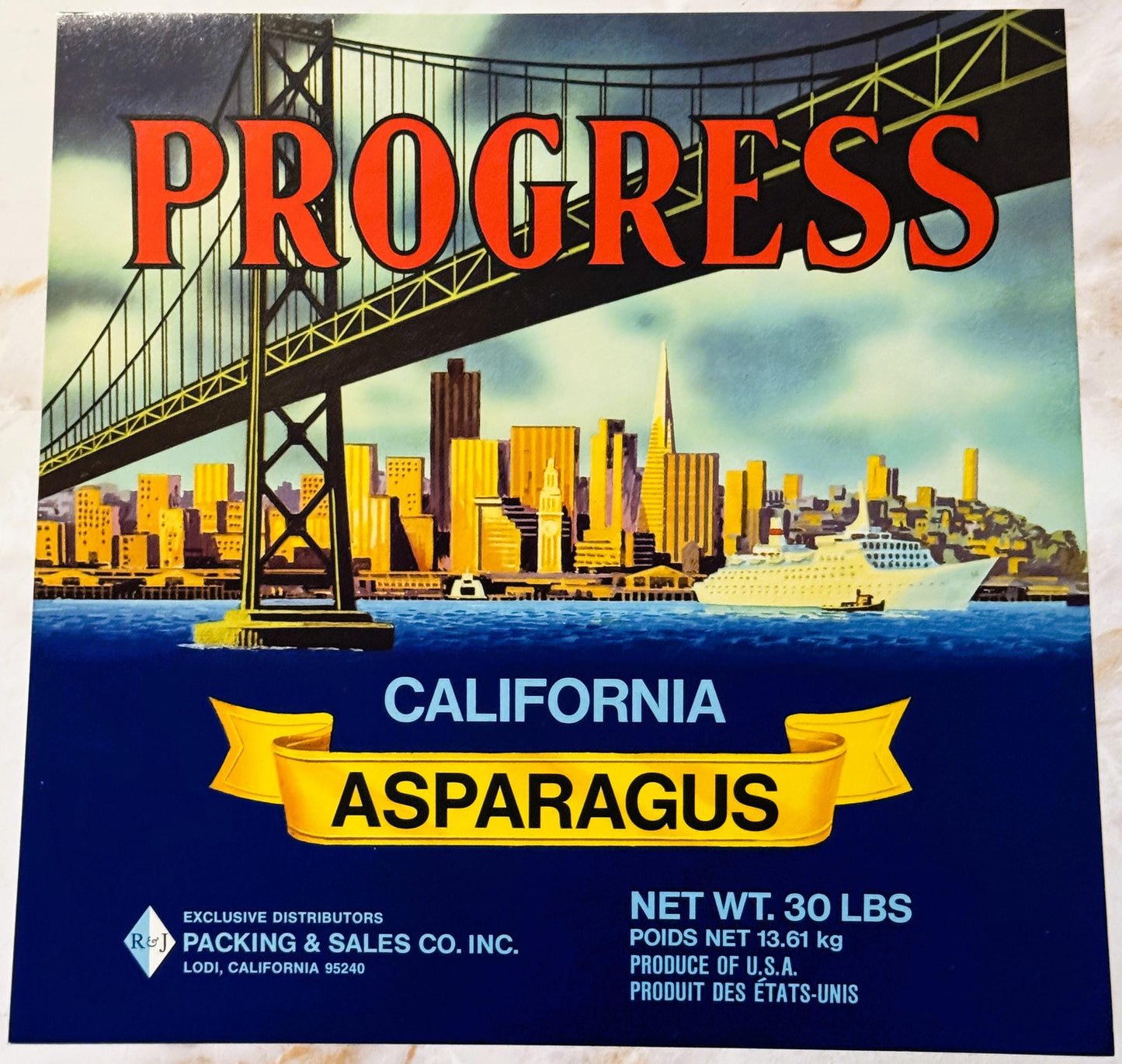 Vintage Progress brand California asparagus crate label featuring San Francisco skyline and Golden Gate Bridge in yellow and 