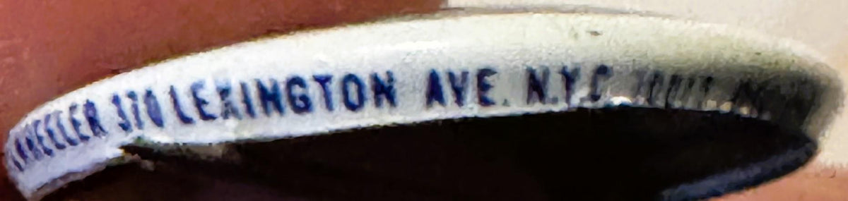 Close-up of vintage campaign button with blue text reading "NIXON LEXINGTON AVE N.Y.C" on white curved surface against red ba
