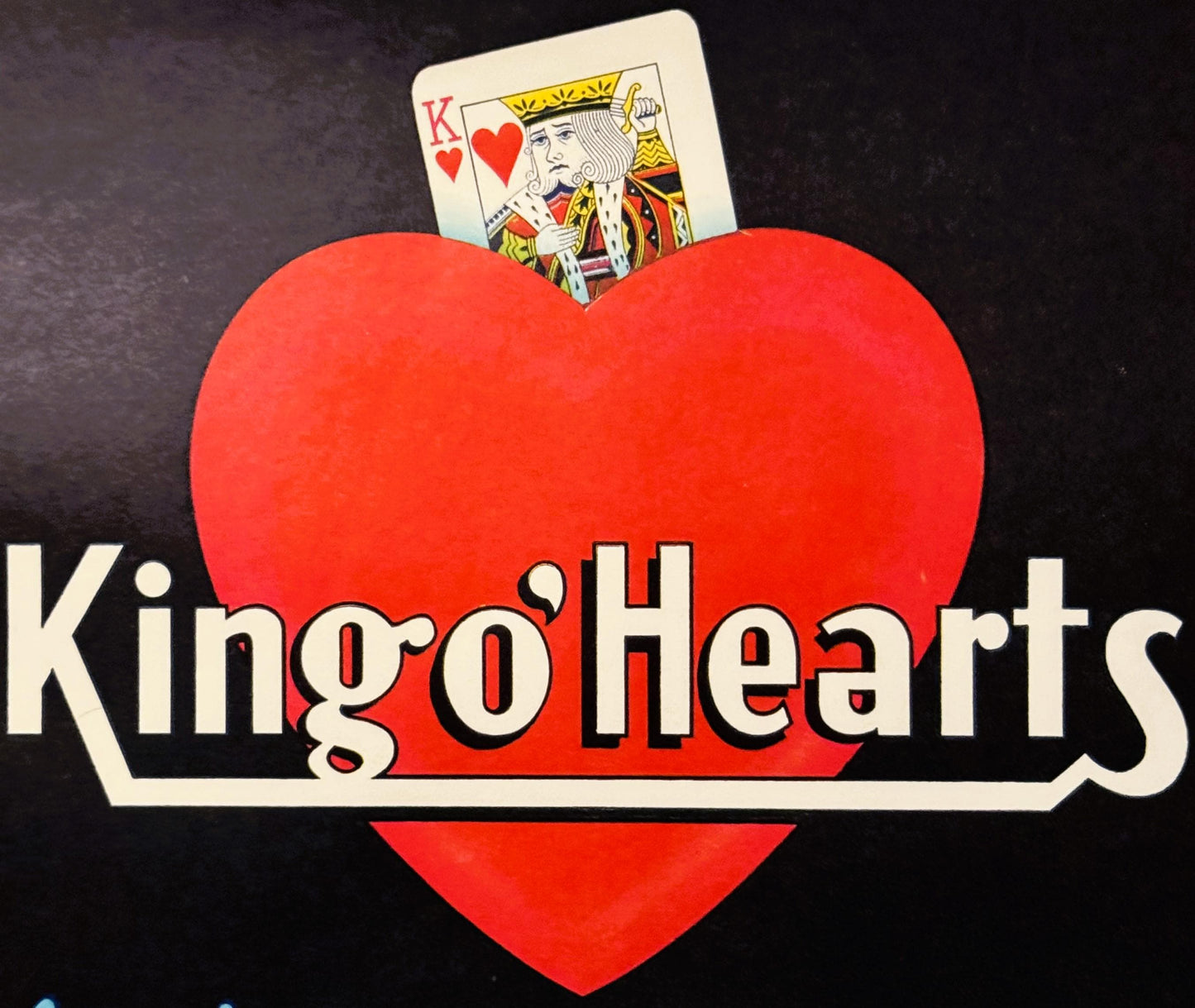 Red heart-shaped label with King of Hearts playing card inserted at top, "King o'Hearts" text below on black background