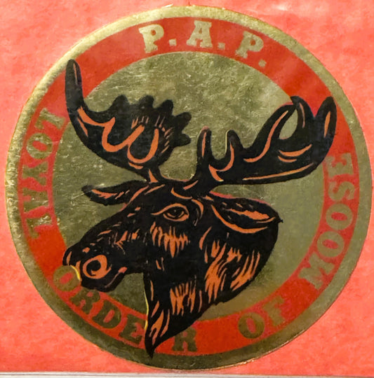 Circular emblem with black moose head outlined in orange on gray center, surrounded by red band with "R.A.P." at top and "LOY