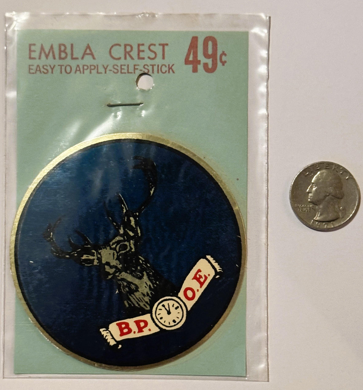 Vintage self-stick emblem crest featuring elk head on dark blue circle with B.P.O.E. banner, shown next to quarter for scale.