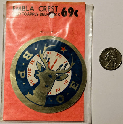 Vintage BPOE Elks emblem decal on red packaging with quarter coin for scale, showing deer head with antlers in blue and cream