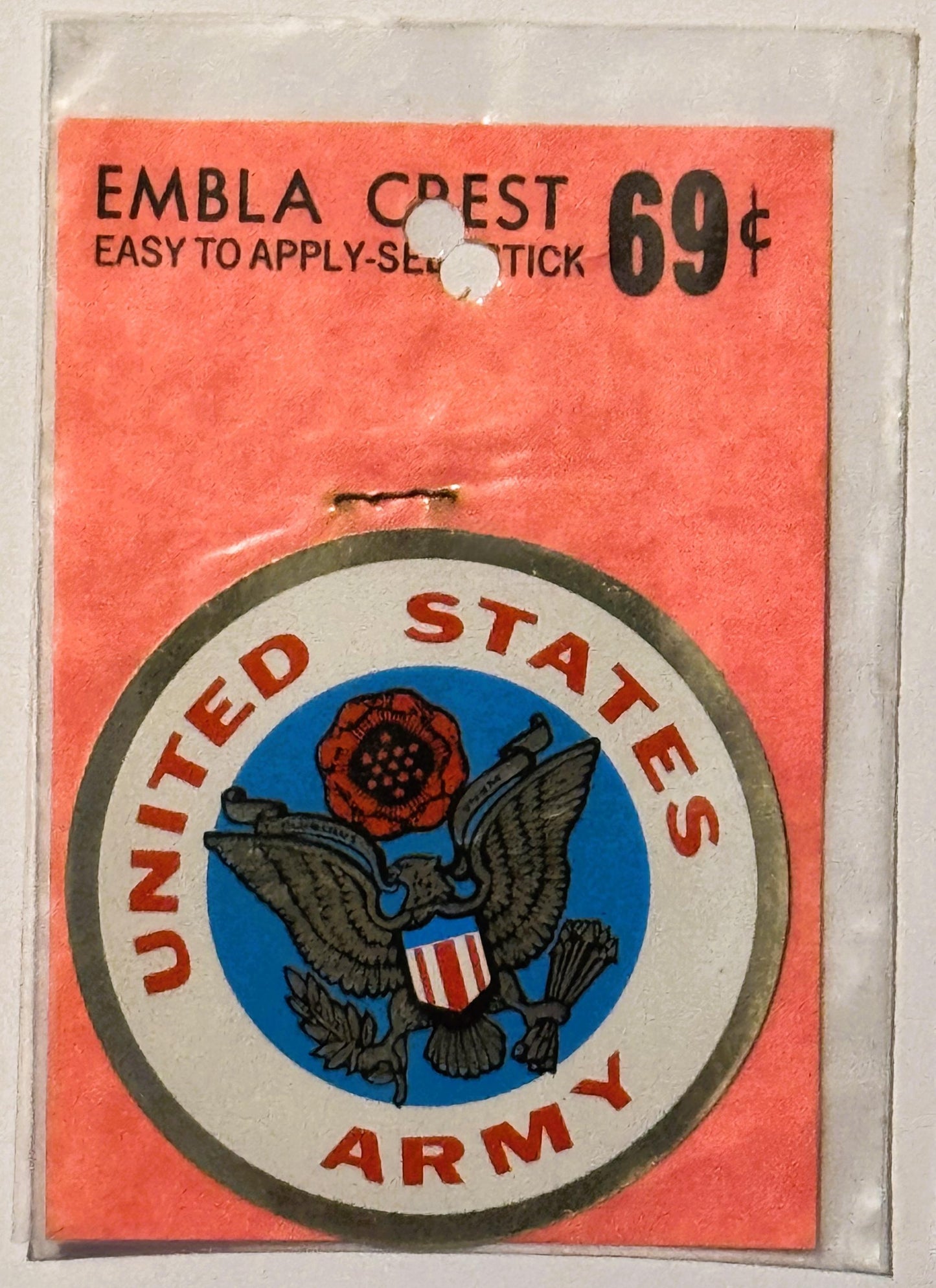 Vintage United States Army emblem decal on coral-red backing, priced 69 cents, self-stick application, shown in clear plastic