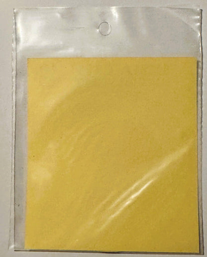 Vintage yellow decal in clear plastic sleeve with hanging hole, displayed against white background