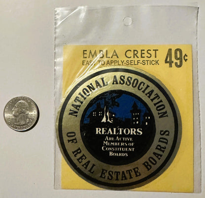 Vintage self-stick emblem decal priced 49¢ showing National Association of Real Estate Boards seal with cityscape, next to qu