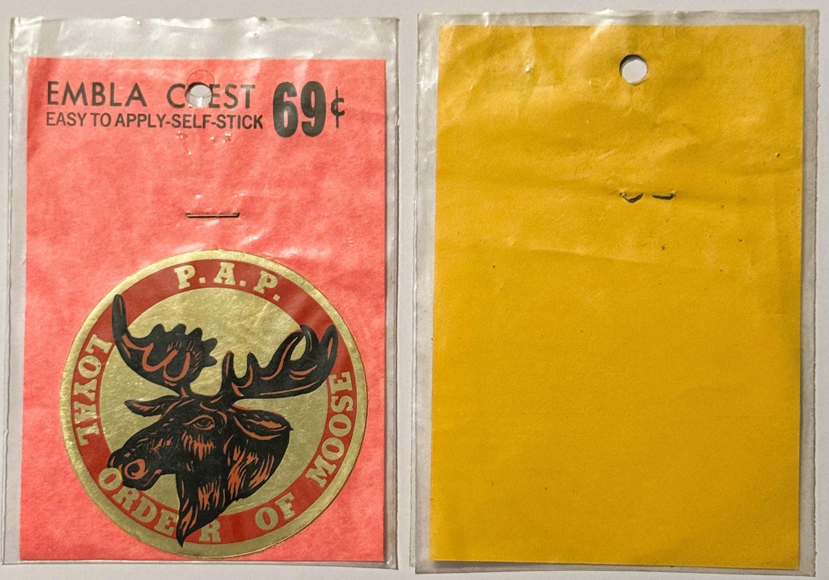 Vintage self-stick embla crest decal priced 69 cents, showing moose head emblem in packaging, front and back visible