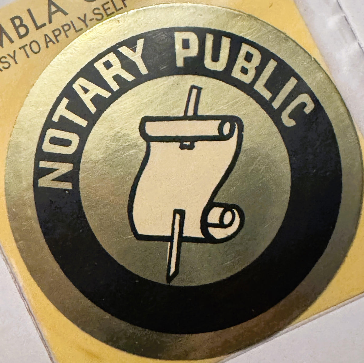 Vintage notary public decal featuring a thumbprint icon in a circular black and tan design with embossed lettering on yellow 