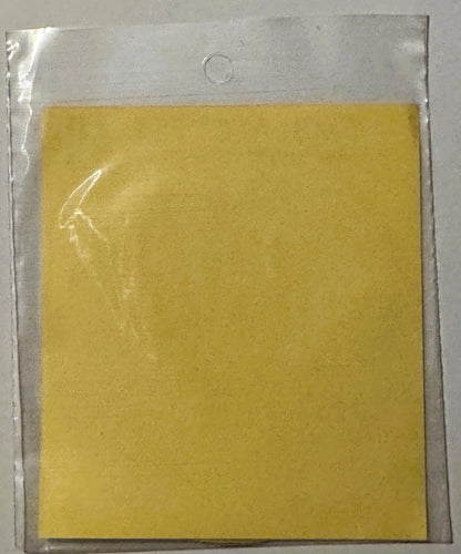 Vintage yellow decal sticker in clear plastic sleeve with hanging hole, plain surface visible from front angle