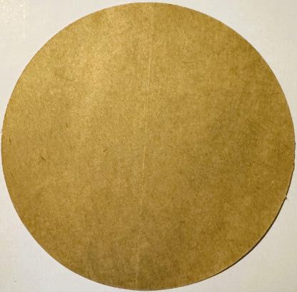 Circular tan cardboard backing or substrate with textured surface, photographed straight-on against white background