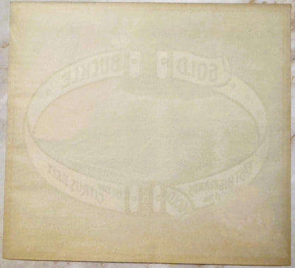 Cream-colored embossed fruit crate label with oval center design and text reading "Gold Buckle" and "Sunkist," photographed f