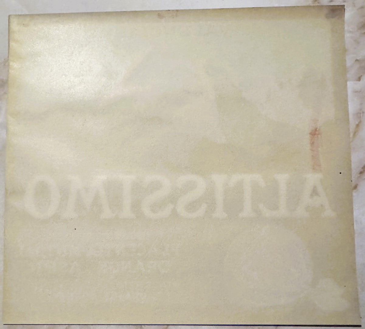 Back of the Altissimo crate label: plain paper with ALTISSIMO and the packer lines showing faintly through in reverse