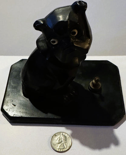 Black cast metal Art Deco bulldog inkwell on rectangular base with quarter coin for scale, shown from front angle against whi