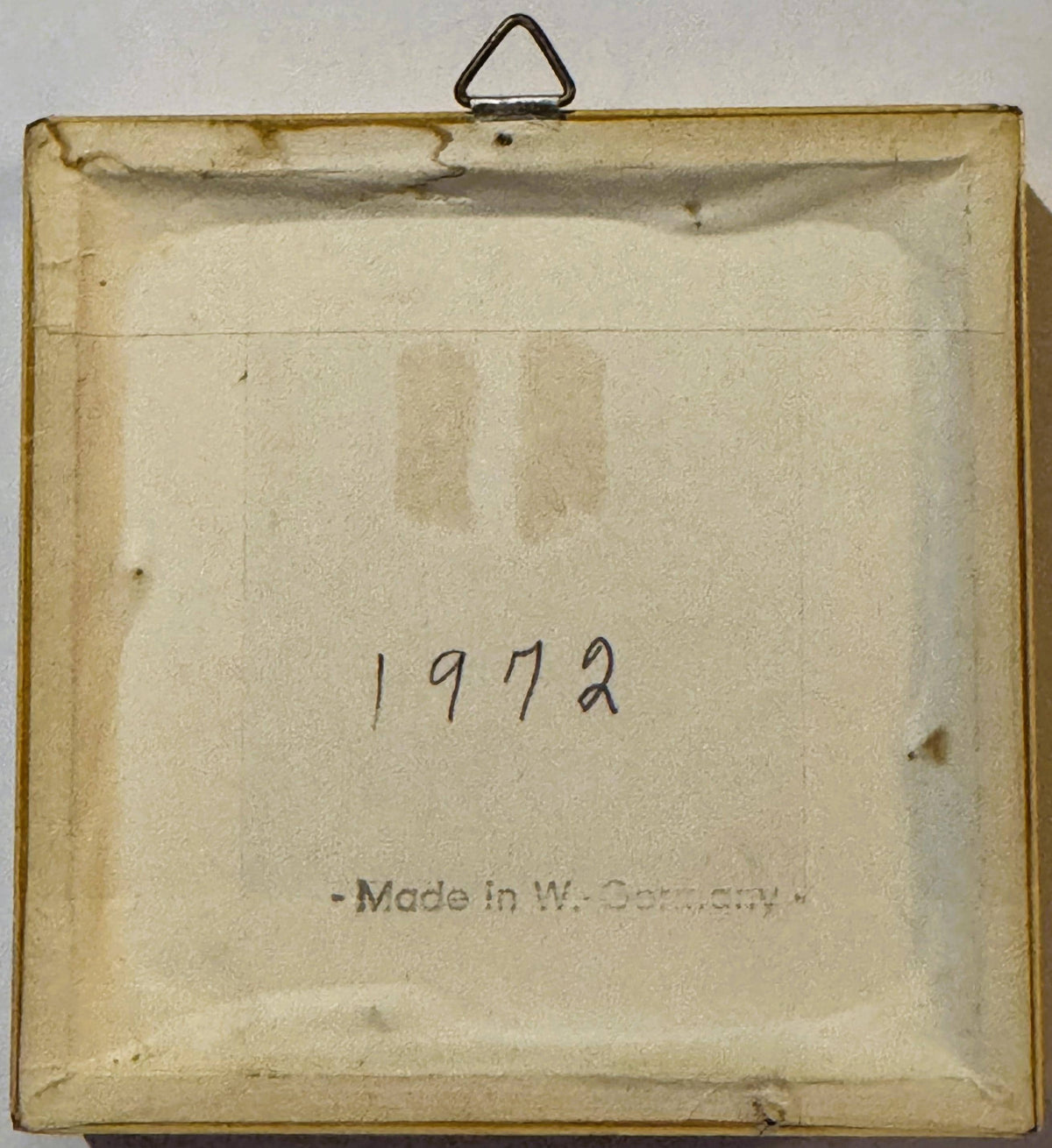 Back of the frame: cream paper backing printed "- Made in W.-Germany -" with "1972" handwritten in ink, and a triangular metal hanger.