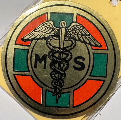 Vintage medical caduceus decal with winged staff and snakes, surrounded by red and green colored sections, letters M and S vi