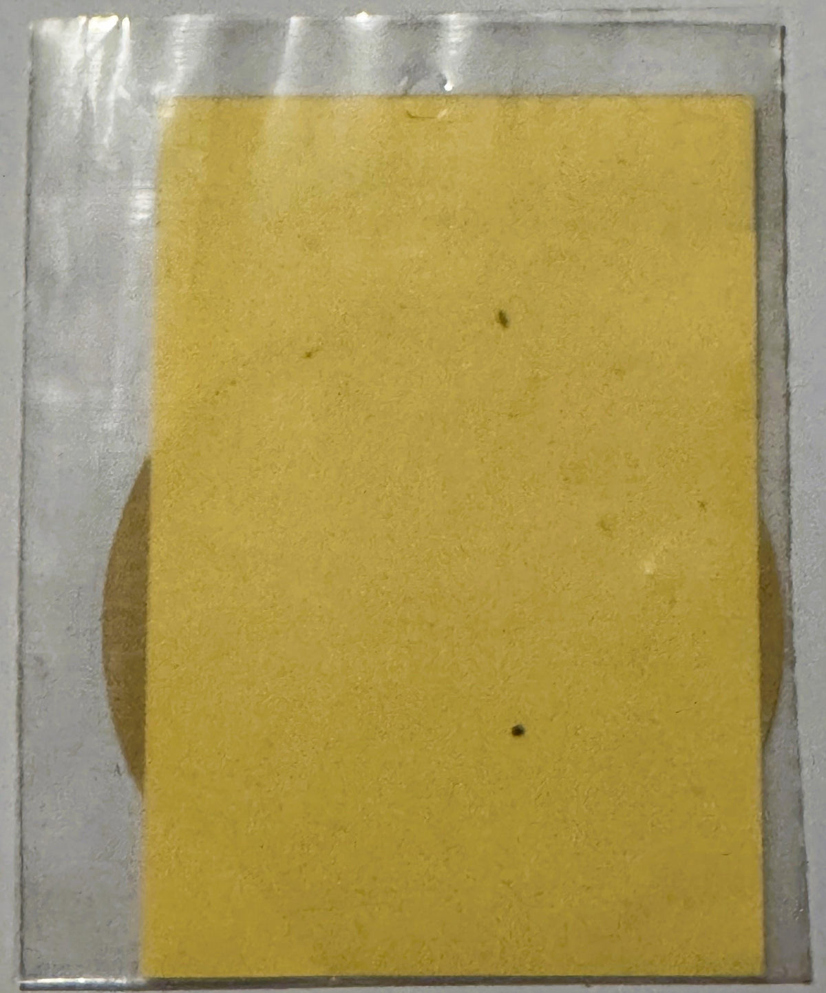 Yellow vintage decal sheet in clear plastic packaging, shown flat against gray background