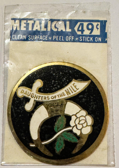 Vintage metallic decal sticker priced 49¢ featuring "Daughters of the Nile" emblem with cornucopia and flower on black backgr