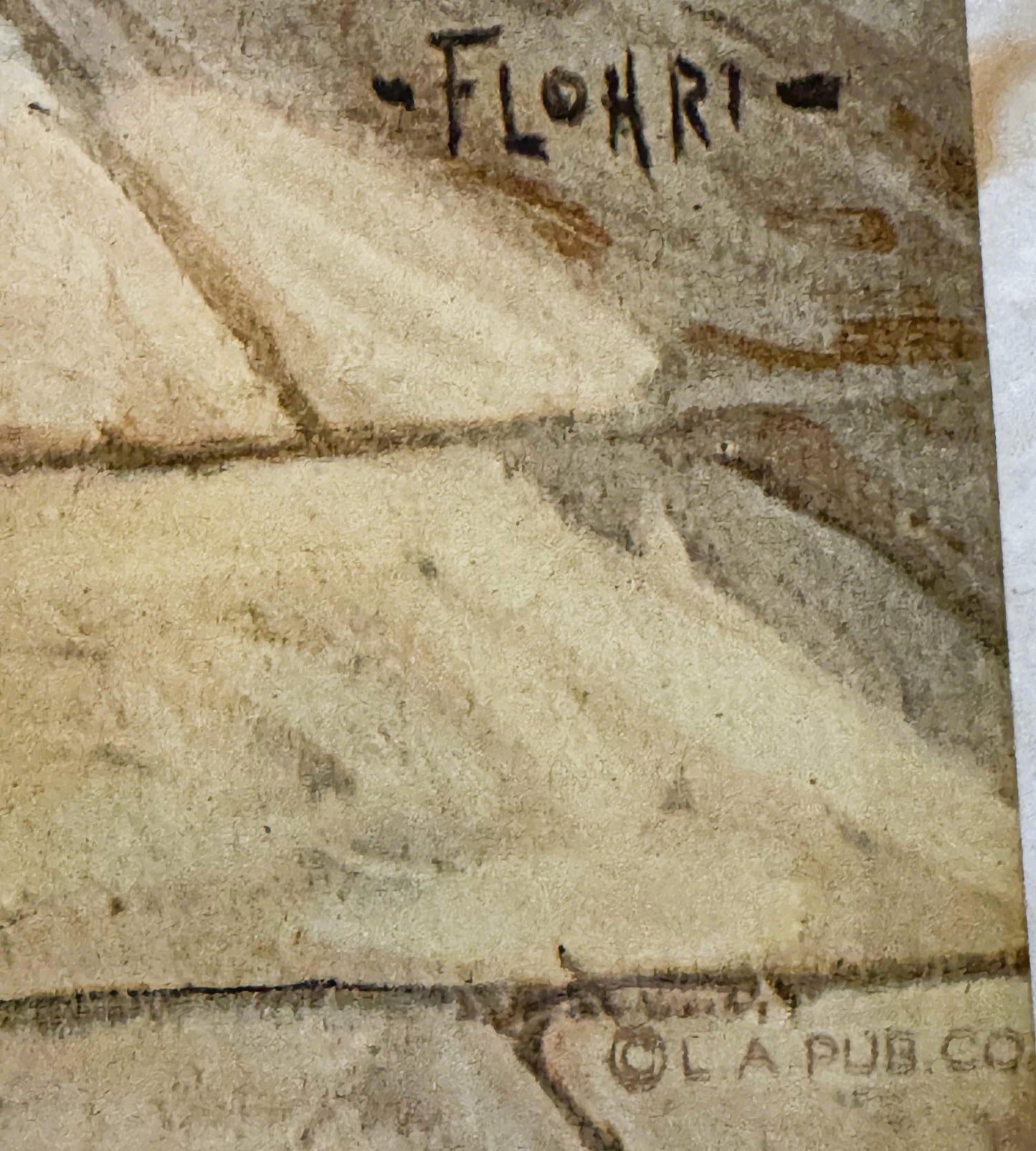 Close-up of aged print corner showing "FLOHRI" text at top and "©L PUB.CO" at bottom, tan paper with dark creasing and wear m