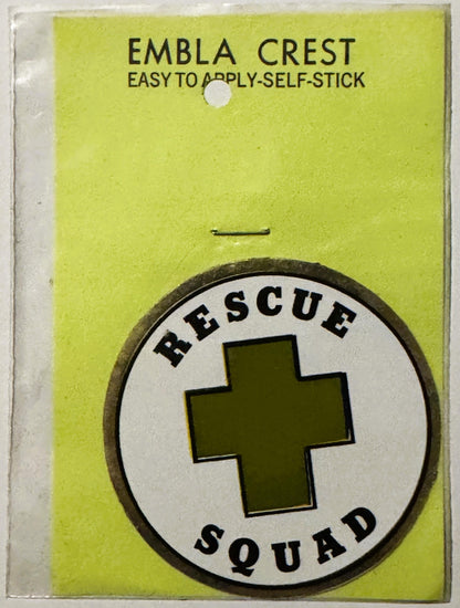 Unopened vintage Rescue Squad emblem crest decal on yellow-green backing with self-stick application instructions, featuring 