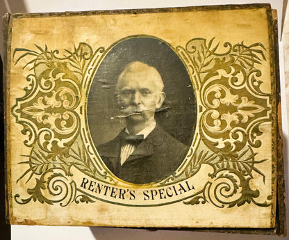 Ornate vintage cigar box lid with gold filigree border, oval portrait of mustached man in formal dress, "Renter's Special" te