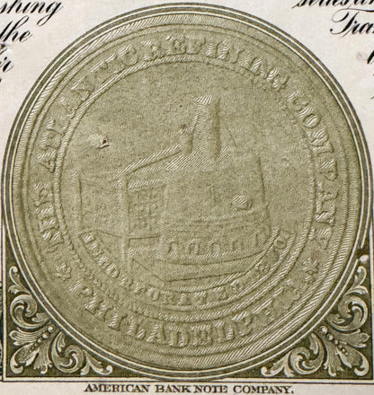 Close-up of ornate circular seal or medallion from vintage stock certificate, embossed with decorative border and central ima