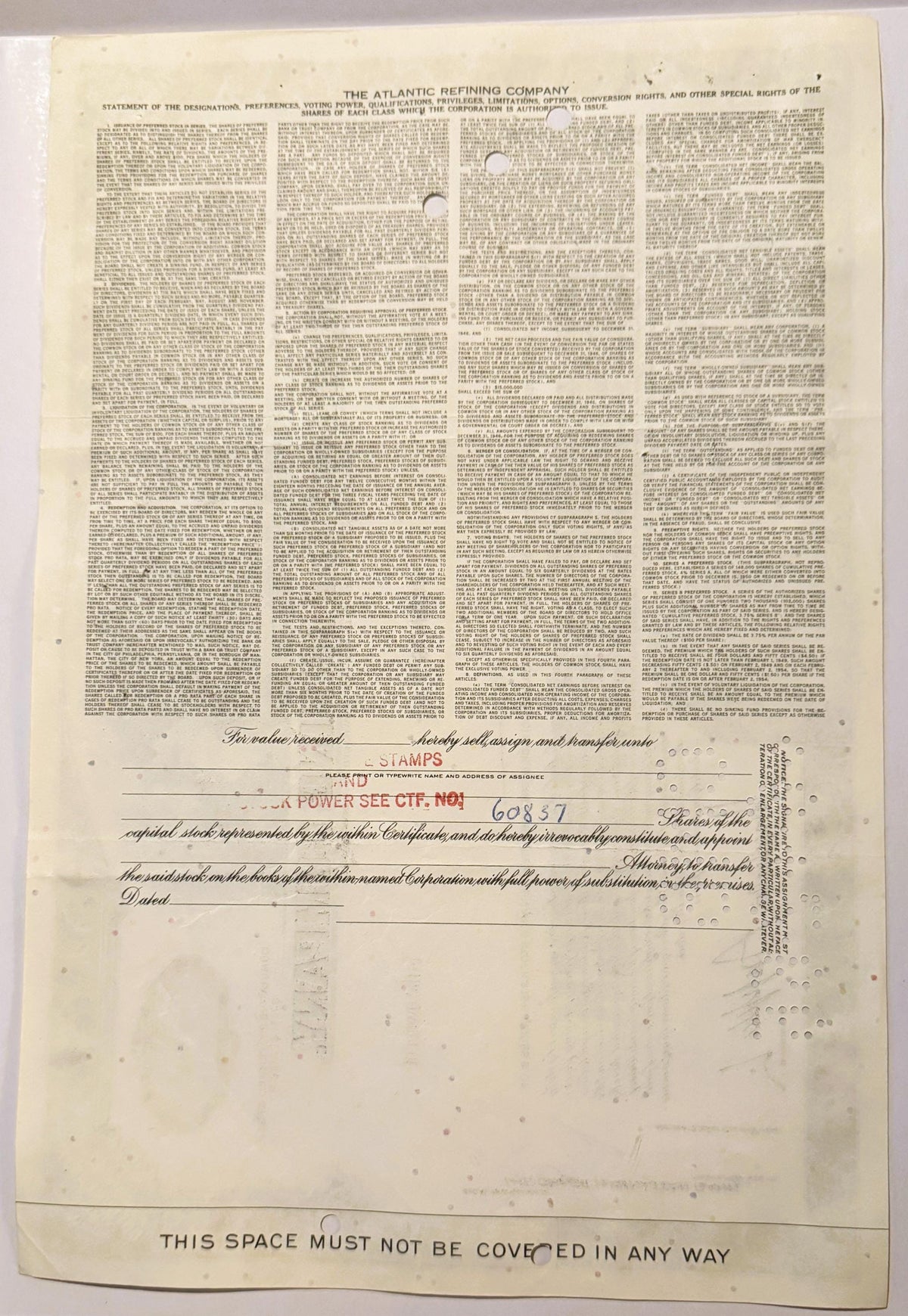 Cream-colored vintage stock certificate from Atlantic Refining Company with dense printed text in four columns and transfer a