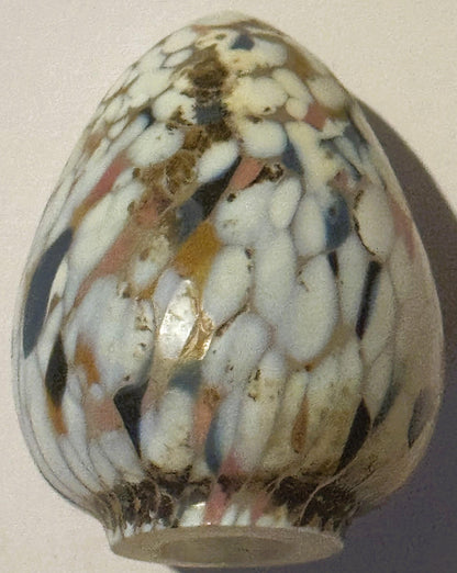 Egg-shaped art glass sculpture with white, cream, brown and rust spatter pattern, shown from front against neutral background