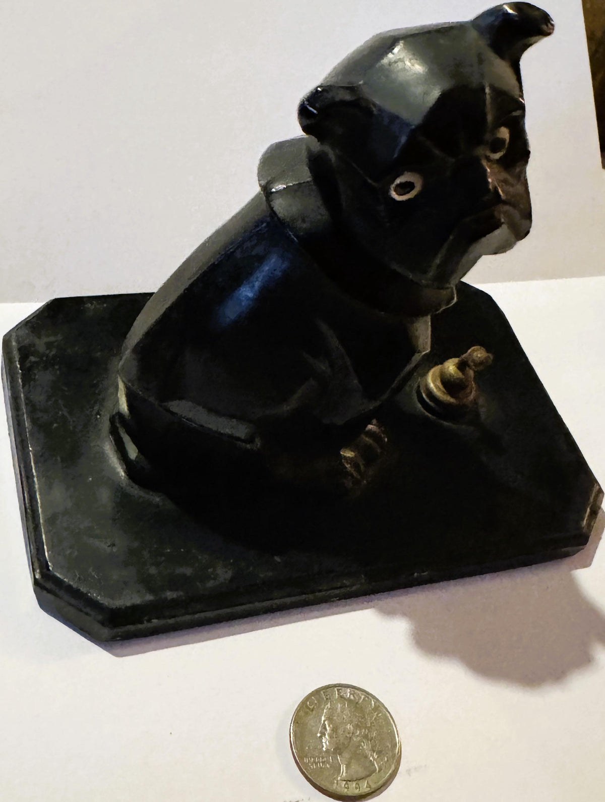Black cast metal Art Deco bulldog inkwell on rectangular base, shown at angle with quarter coin for scale