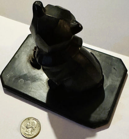 Black cast metal bulldog head inkwell on rectangular base, photographed from above with a quarter coin for scale