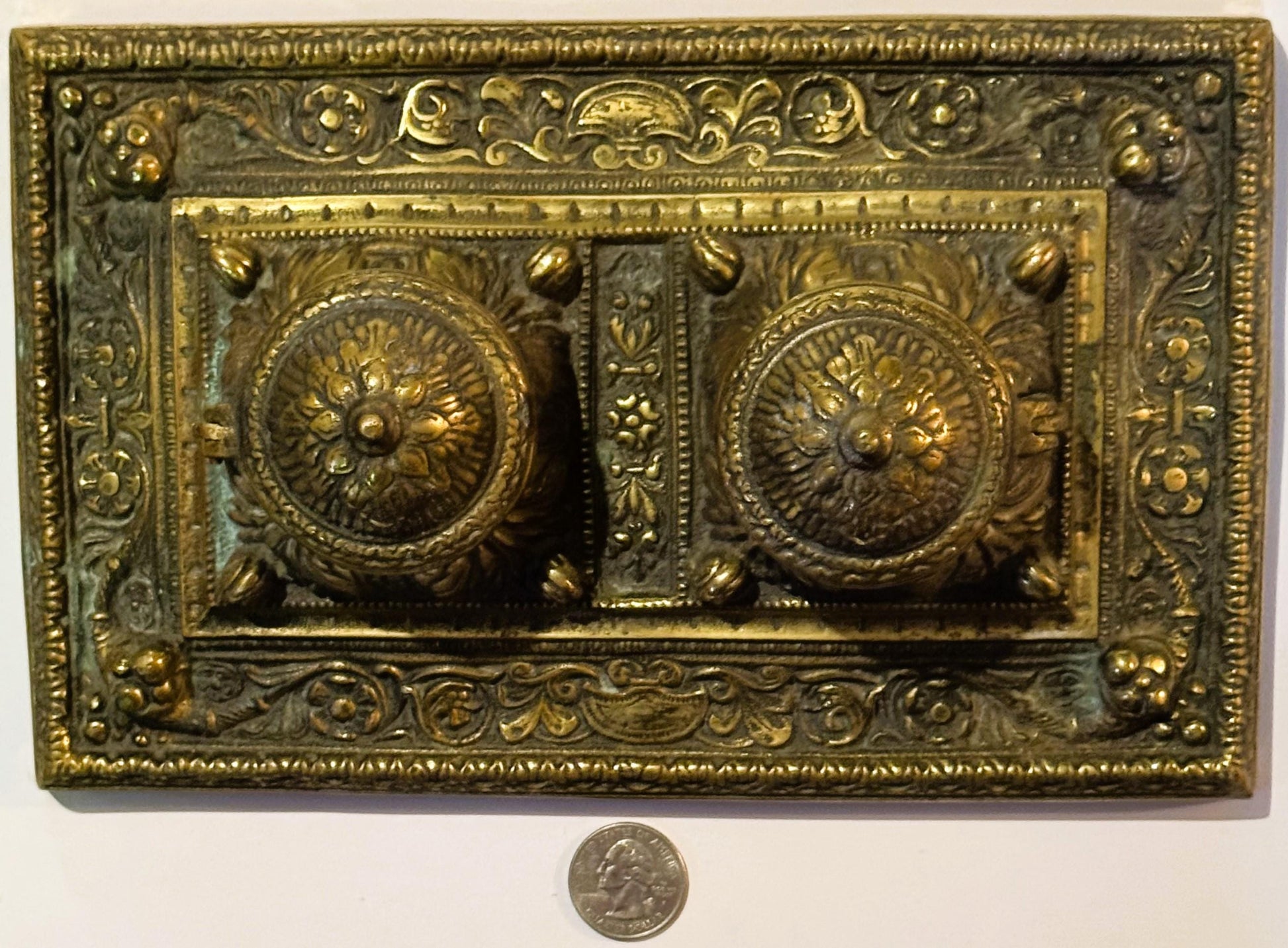 Ornate brass double inkwell desk accessory from late 19th century with floral designs