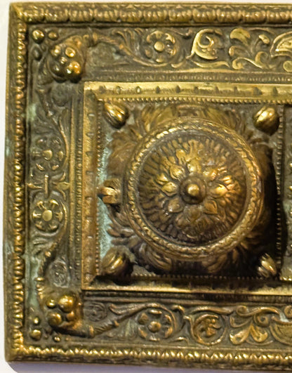 Ornate aged brass double inkwell desk accessory from late 19th century