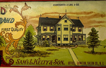 Vintage tomato can label featuring a yellow farmhouse, decorative flourishes, and text reading "Defy The World" and "Saml. Ke
