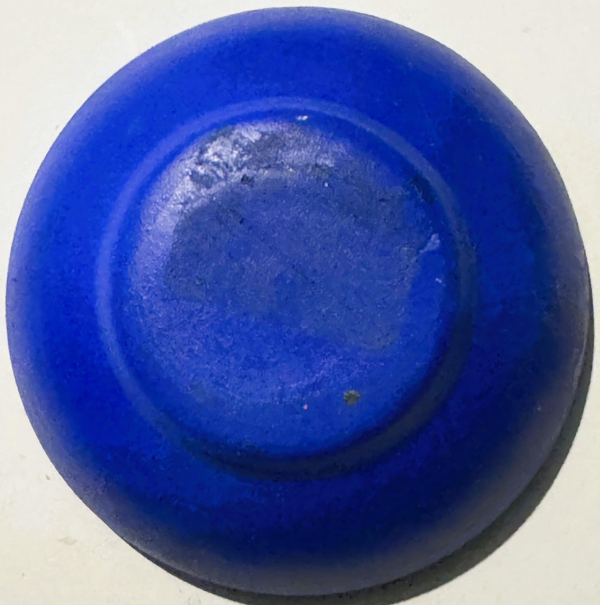 Blue ceramic bowl viewed from above, showing interior base with lighter textured surface and concentric ring design
