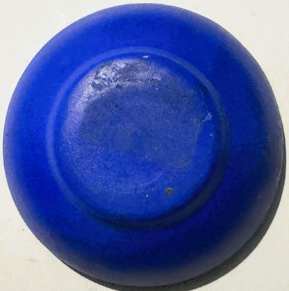 Blue ceramic bowl viewed from above, showing interior base with lighter textured surface and concentric ring design