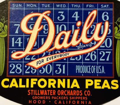 Vintage Daily Brand peas crate label with calendar grid, red and cream lettering on blue background, from Stillwater Orchards