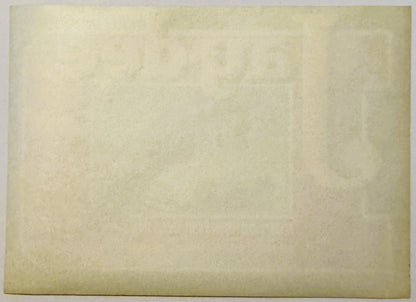 Cream-colored vintage crate label with faded text and subtle printed design, photographed flat against neutral background