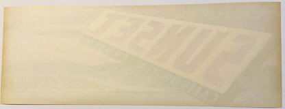 Vintage fruit crate label with faded Sunset brand text and illustration on aged cream-colored paper, photographed flat.