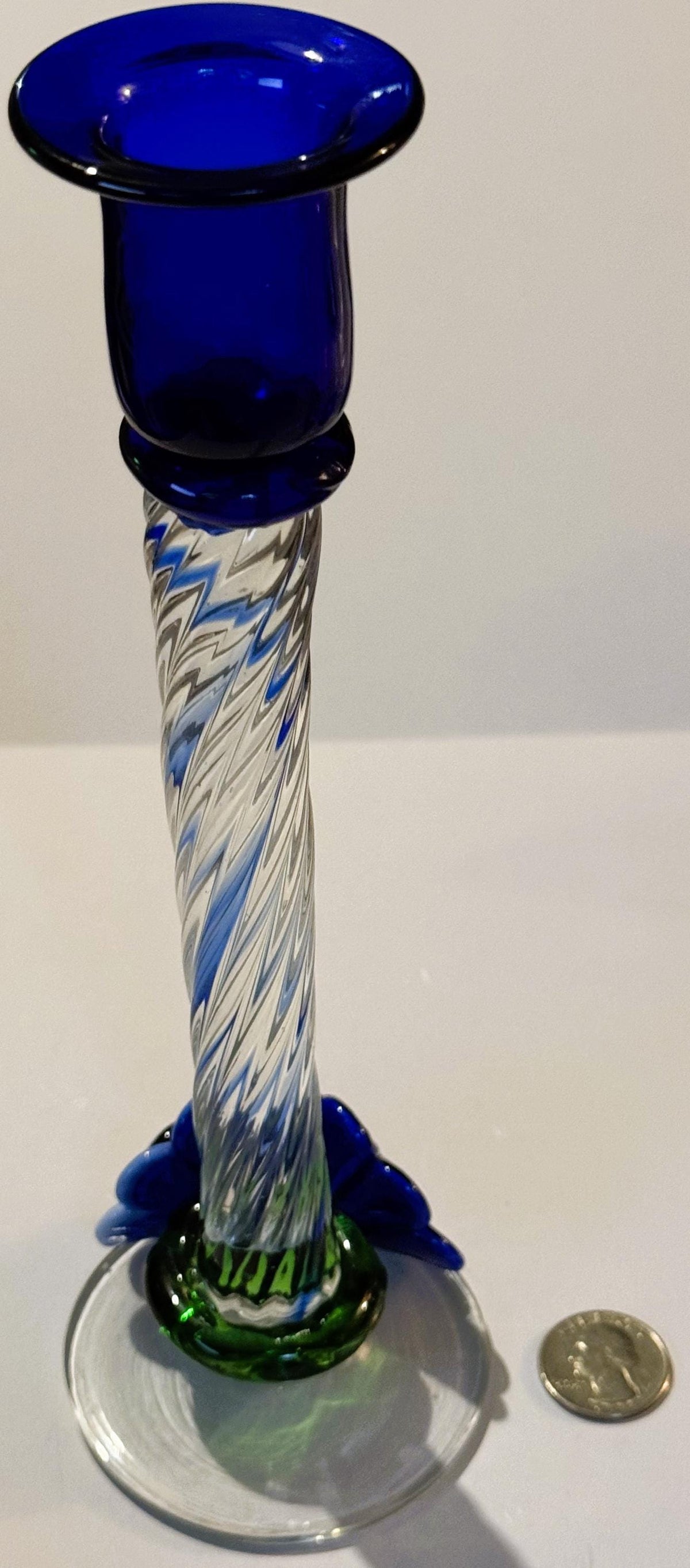 Tall blue glass candlestick with twisted white and blue latticino stem, green base, and coin shown for scale.