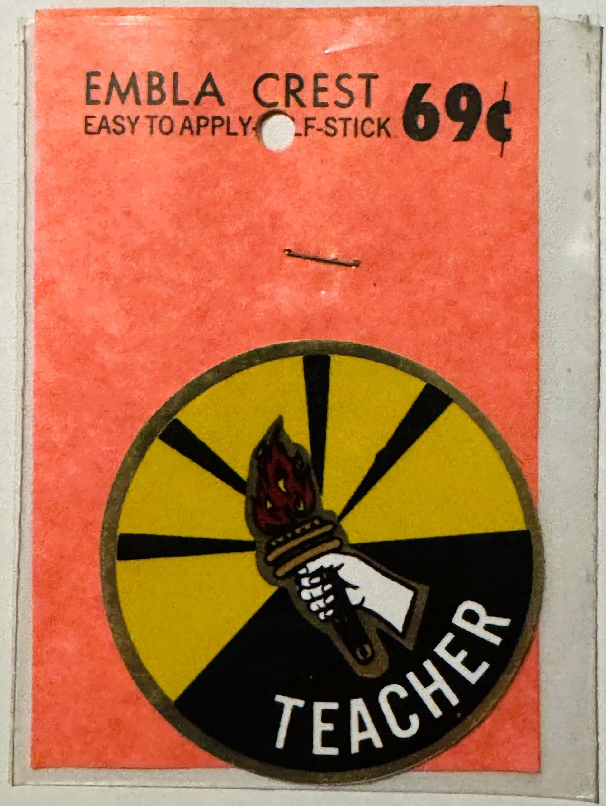 Vintage orange decal with torch and "Teacher" emblem, priced 69 cents, easy-to-apply stick-on style