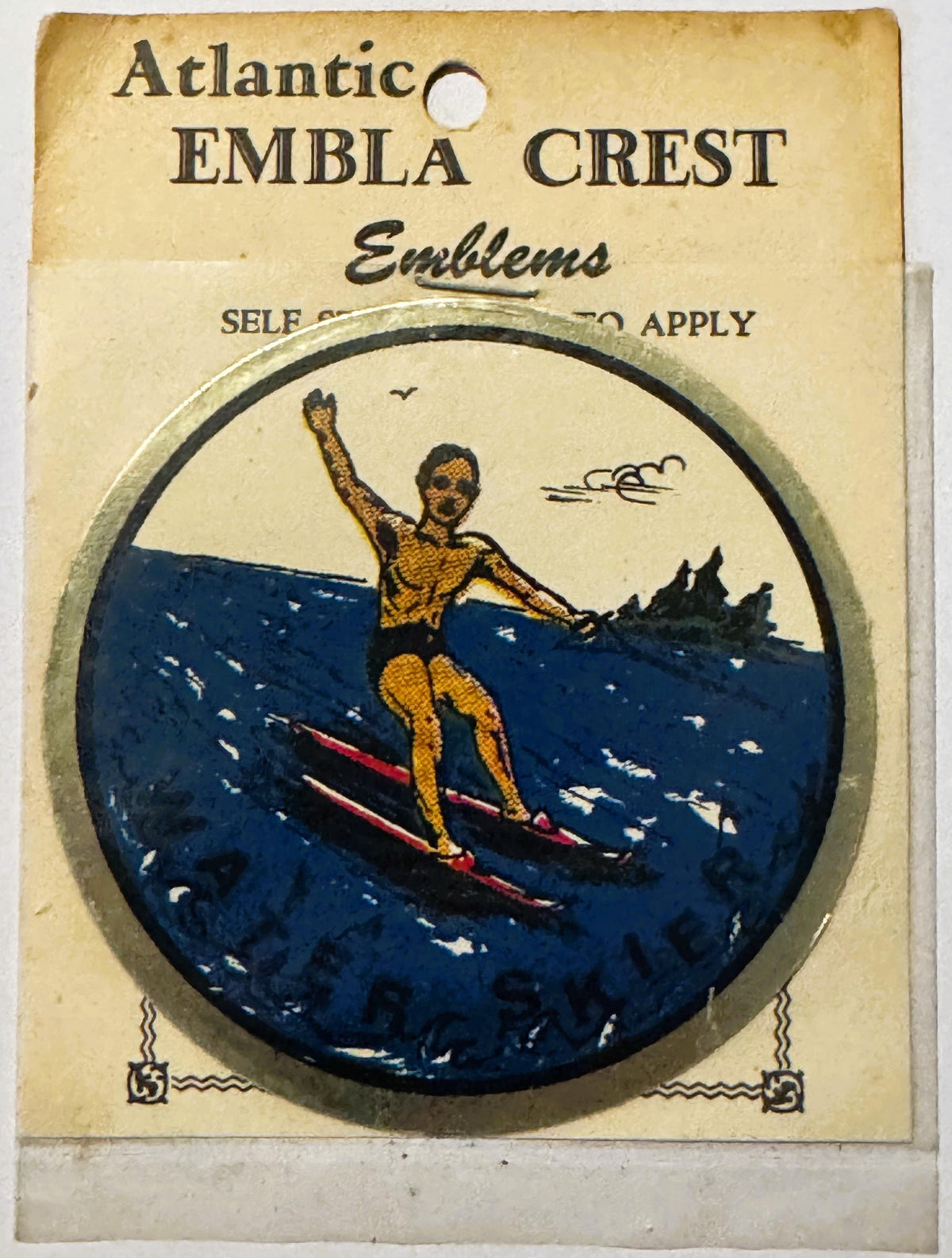 Vintage Atlantic Embla Crest water skier decal package showing a figure in yellow on red skis against dark blue water, unopen