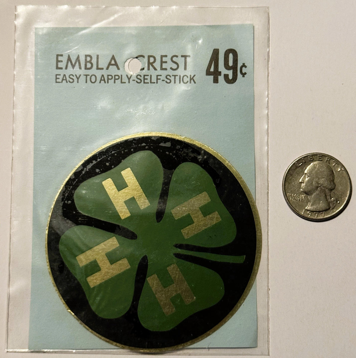 Vintage Embla Crest self-stick decal featuring green four-leaf clover with gold "4-H" letters on black background, priced 49¢
