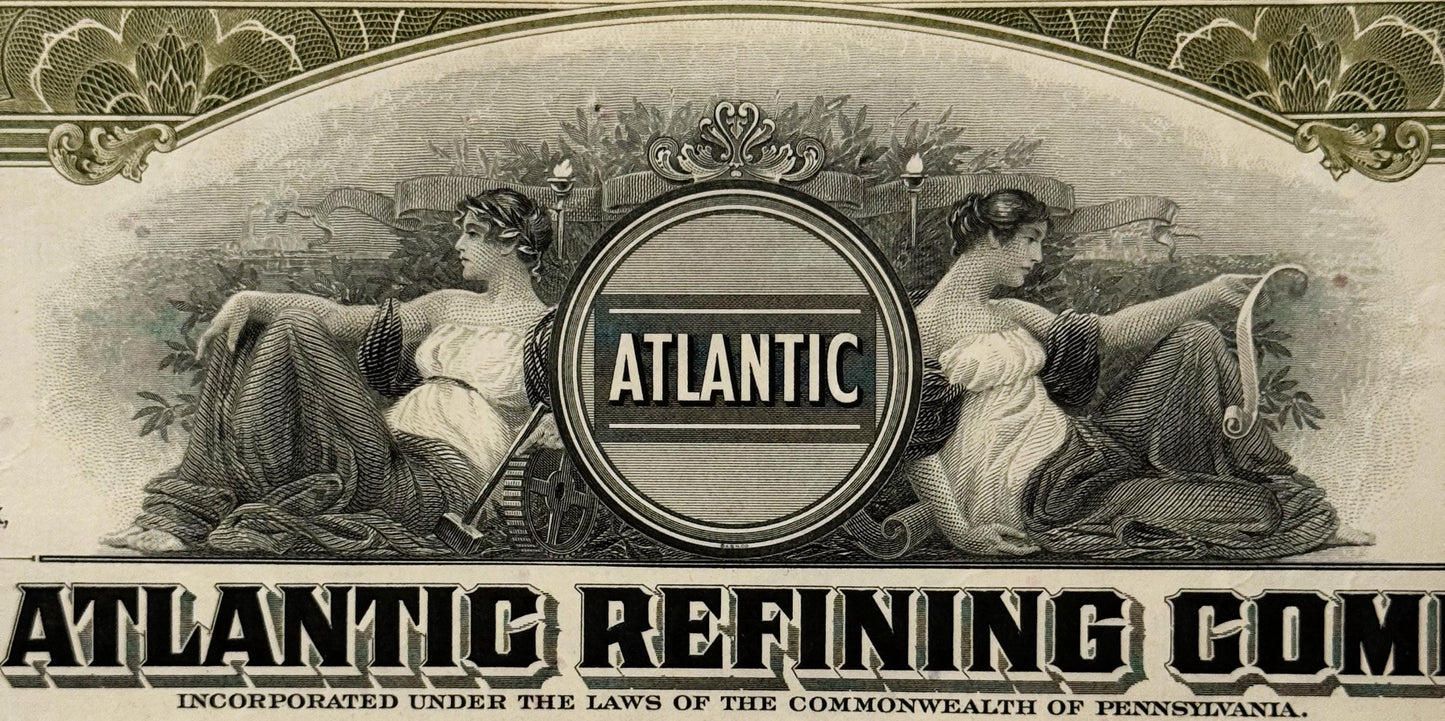 Ornate vintage stock certificate header for Atlantic Refining Company showing two classical female figures flanking a circula