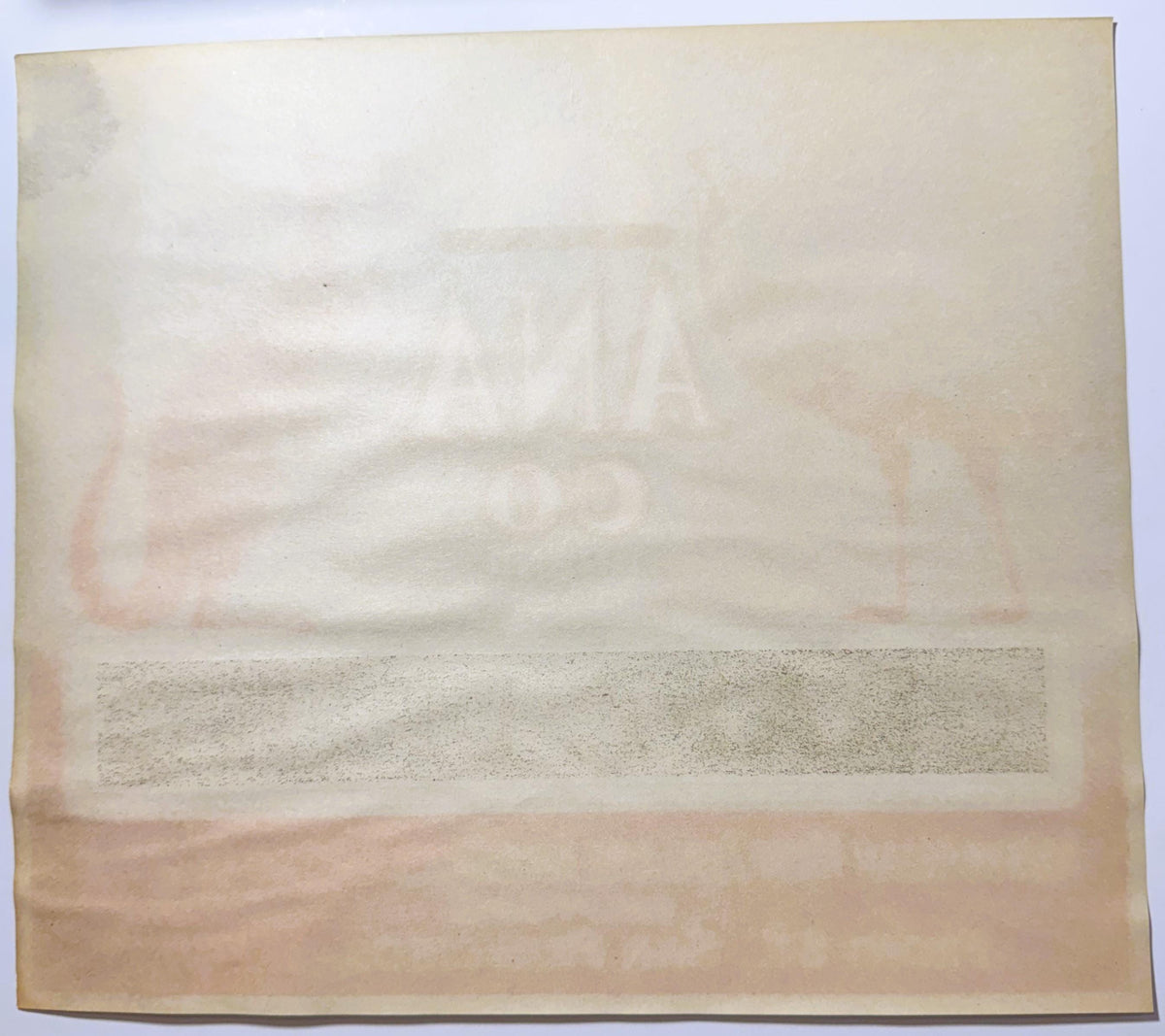 Back of the ANA CO Grape Fruit label: blank cream stock with the front's ANA CO lettering and animal art ghosting through in mirror image.