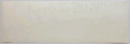 Faded vintage crate label with cream background and barely legible text, photographed flat against white surface