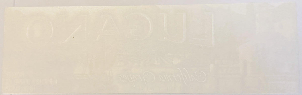 Cream-colored vintage crate label with embossed text reading "Lugano Grapes" and "Fresno, CA," shown at full size against whi