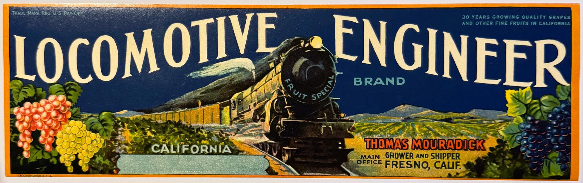 Vintage fruit crate label featuring a steam locomotive with "Locomotive Engineer" brand text, grapes, and California landscap