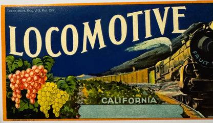 Vintage fruit crate label with "Locomotive" text, red and yellow grapes, and steam train illustration on dark blue background
